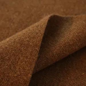 Close-up of thick dark brown wool blend fabric showing fine texture and warm fibers