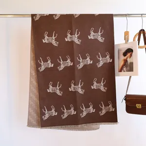Detail of horse jacquard pattern and short fringe on double-sided cashmere-like scarf