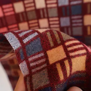 Macro shot of the thick woven plaid fabric detail with colorful fringe and warm texture