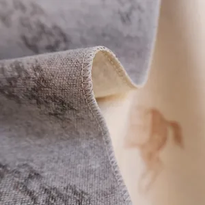 Macro detail of overlock stitching and horse pattern on a thick reversible shawl scarf