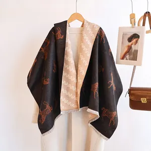 Detail of double-sided scarf with horse pattern and jacquard tassels for winter warmth