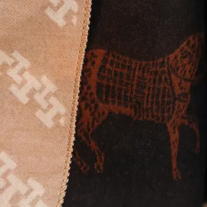 Close-up of double-sided jacquard scarf featuring horse motifs and leopard animal print