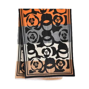 Winter camellia pattern cashmere-feel scarf with geometric color blocks and fringe trim