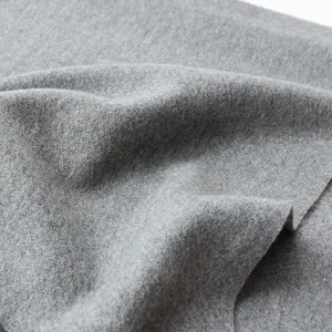 Macro view of gray wool scarf fabric showing soft texture and fine fuzzy material surface