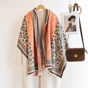 Close-up of double-sided paisley cashmere-feel scarf with elegant fringe detail