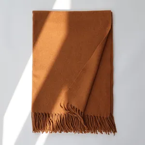 Close-up of caramel wool scarf showing delicate texture and handmade fringe tassels