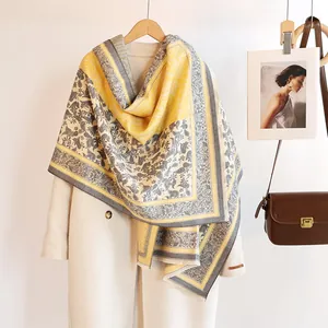 Close-up of cashmere-feel shawl featuring paisley patterns and soft fringe edges