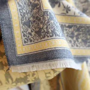 Macro detail of paisley cashmere-feel scarf showing fine texture and white tassel fringe