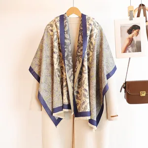 Close-up of luxury paisley cashmere shawl over a wool coat with thick soft texture