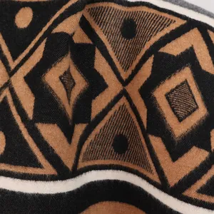 Close-up of ethnic Maya pattern on thick cashmere-like shawl with soft fringe texture