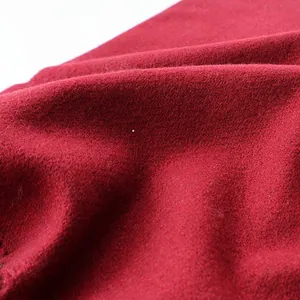Macro shot of dark red wool scarf material showing soft brushed texture and fibers
