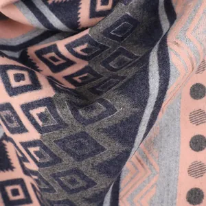 Macro detail of the ethnic Mayan geometric knit pattern and soft cashmere-like fabric texture