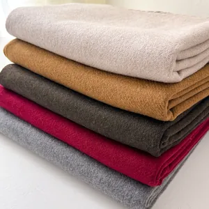 Folded classic wool scarves in cream, camel, coffee, wine red, and grey with soft texture