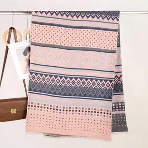 Close-up of Mayan style pink and grey scarf with geometric jacquard and fringe edges