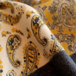 Macro shot of yellow and gray paisley pattern cashmere-like pashmina scarf texture
