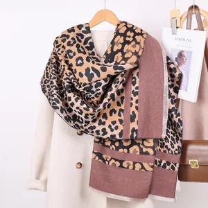 Detail of leopard print scarf with fringe edges and brown color-blocking design