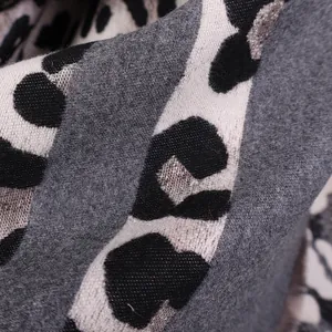 Macro shot of grey leopard print faux cashmere fabric with soft brushed texture