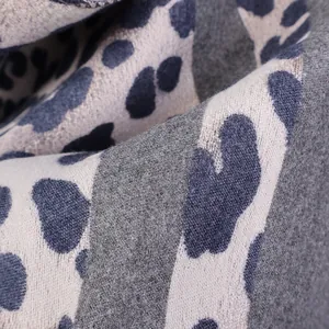 Macro view of the soft leopard print cashmere-like fabric showing fine fibers and texture