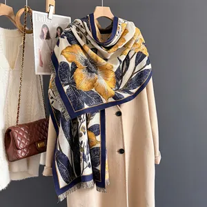 Floral print cashmere scarf with yellow flowers and fringe on beige wool coat