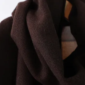 Nahaufnahme des dunkelbraunen Wollschal-Stoffs mit weicher Textur und feiner Faserung