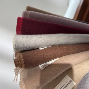 Detail of wool muffler scarves in multiple colors with soft texture and fringe edges