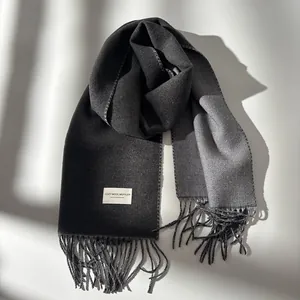 Premium thick charcoal grey wool muffler for women with stylish tassel edges and woven label