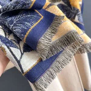 Detailed macro view of woven floral jacquard fabric with elegant grey fringe trim