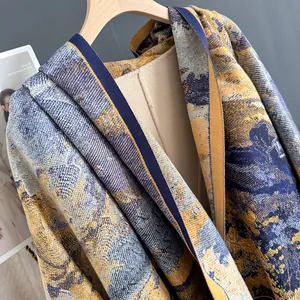 Close-up of artistic knit jacquard shawl with blue and yellow abstract landscape pattern