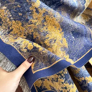 Luxurious cashmere-like jacquard scarf with artistic navy and gold pattern and tassels