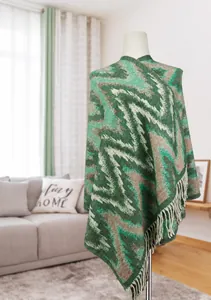 Detailed knit texture of green and beige ethnic pattern shawl with white tassels