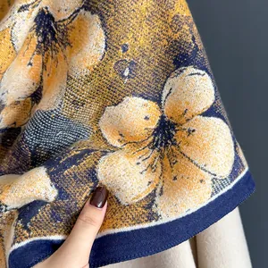 Detailed close-up showing high-density jacquard flower patterns on yellow cashmere scarf