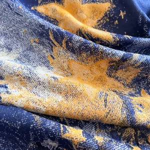 Detailed macro view showing the thick navy blue fabric texture with golden star patterns