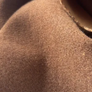 Close-up of thick premium wool fabric texture on a dark brown scarf detail
