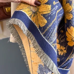 Detail of navy blue and yellow floral pashmina with thick texture and fringe
