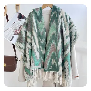 Detail of green wavy pattern jacquard knit scarf with long fringe on a beige coat