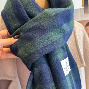 Close-up of thick plaid scarf in navy and green with soft brushed cashmere feel