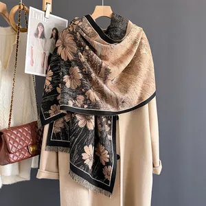 Detailed view of daisy pattern pashmina texture and tassel edge on winter scarf