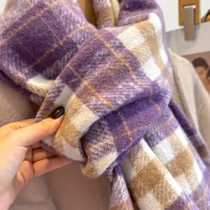 Close-up of soft purple plaid wool scarf showing warm brushed texture and fringe details