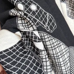 Classic black and white horse jacquard scarf with detailed knit pattern and thick texture