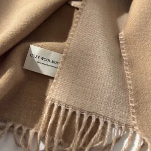 Detail of wool muffler fabric with fine twill weave and elegant fringe tassels