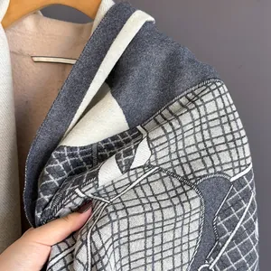 Close-up of the detailed grey and white jacquard pattern on this thick winter scarf