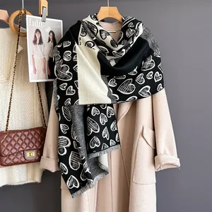 Checkered heart pattern cashmere-feel scarf with tassels on beige wool coat