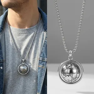 Macro detail of rotating globe pendant and stainless steel box chain for men