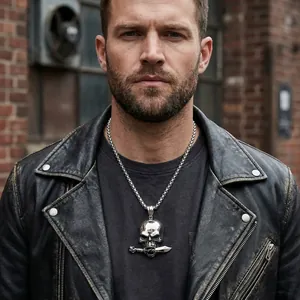Punk style titanium steel skull pendant with dagger detail worn by male model