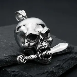 Macro detail view of a gothic punk titanium steel skull pendant with a sword in its mouth