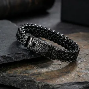 Close-up of punk titanium steel dragon bone bracelet with vintage engraved buckle on slate