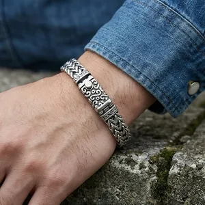 Close-up of punk style dragon bone chain bracelet with engraved vintage floral clasp