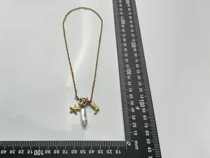 Detailed view of the starfish and baroque pearl necklace charms with size reference