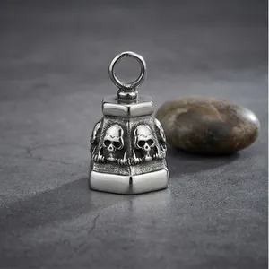 Macro view of vintage punk skull bell pendant with weathered stainless steel finish