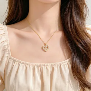 Elegant gold titanium steel necklace with a sparkling heart pendant featuring clear zircons